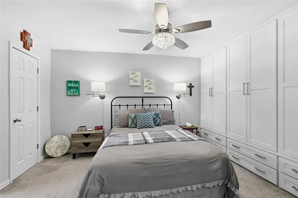 a bedroom with a bed and painting on the wall