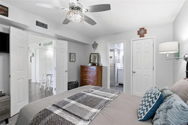 a bedroom with a bed and a chandelier