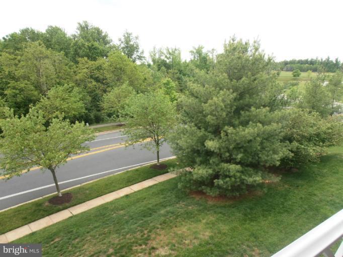 693 Winding Stream Way, Unit 302 Odenton, MD 21113 - Photo 2 of 26 a view of a yard with an outdoor space