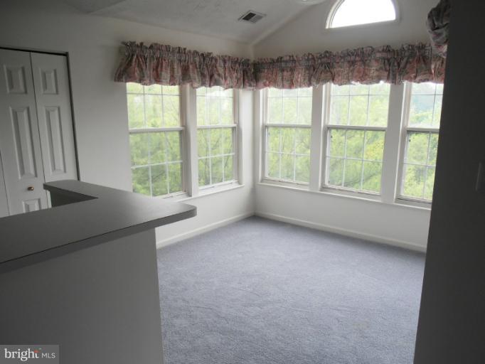 693 Winding Stream Way, Unit 302 Odenton, MD 21113 - Photo 11 of 26 a view of an empty room with a window