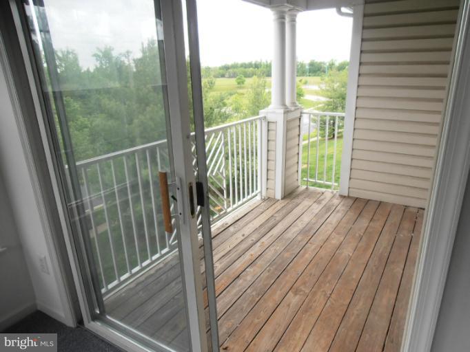 693 Winding Stream Way, Unit 302 Odenton, MD 21113 - Photo 13 of 26 a view of balcony with wooden floor