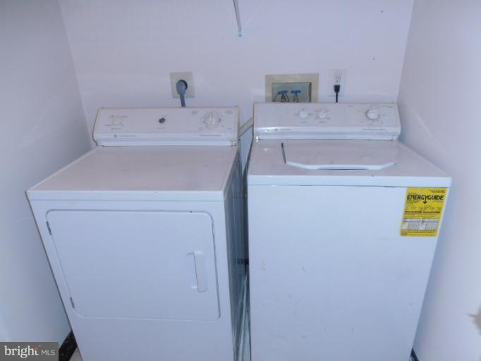693 Winding Stream Way, Unit 302 Odenton, MD 21113 - Photo 18 of 26 a utility room with dryer and washer