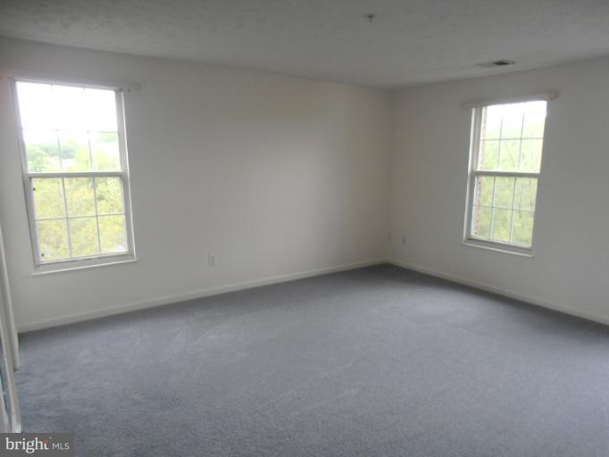 693 Winding Stream Way, Unit 302 Odenton, MD 21113 - Photo 19 of 26 an empty room with a window