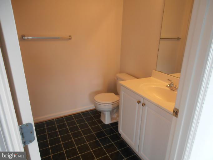 693 Winding Stream Way, Unit 302 Odenton, MD 21113 - Photo 22 of 26 a bathroom with a sink and a toilet