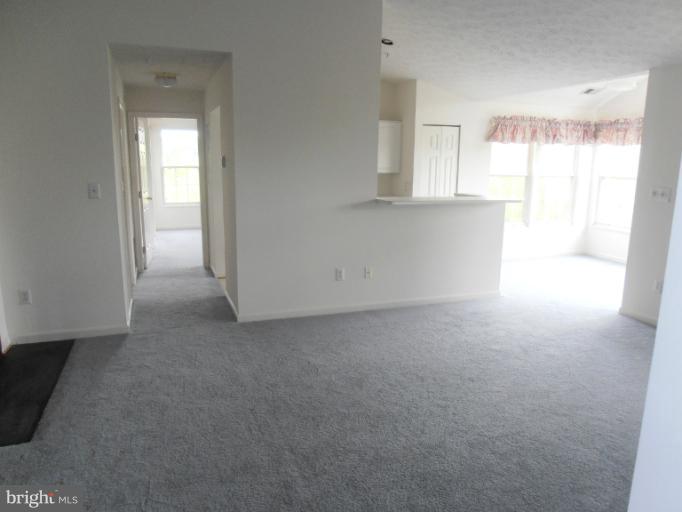 693 Winding Stream Way, Unit 302 Odenton, MD 21113 - Photo 4 of 26 a view of an empty room with a window
