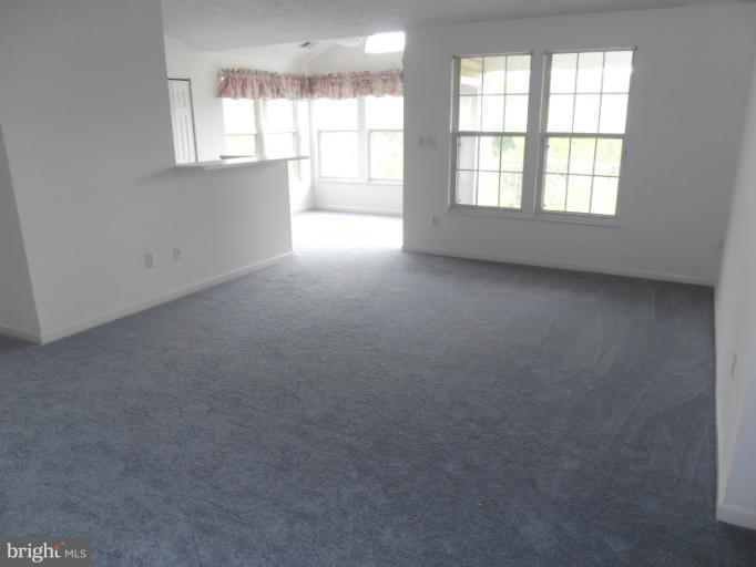 693 Winding Stream Way, Unit 302 Odenton, MD 21113 - Photo 5 of 26 an empty room with windows