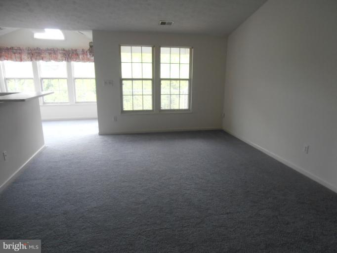 693 Winding Stream Way, Unit 302 Odenton, MD 21113 - Photo 6 of 26 a view of an empty room with a window