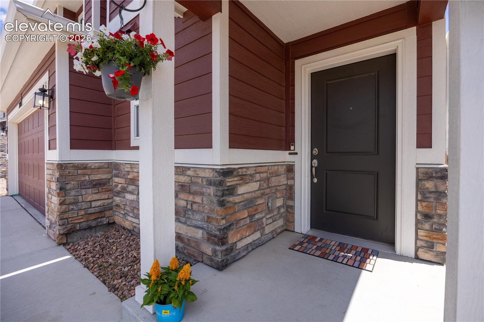 10993 Avena Road Peyton, CO 80831 - Photo 22 of 42 Inviting front entry featuring a paneled black door with white trim