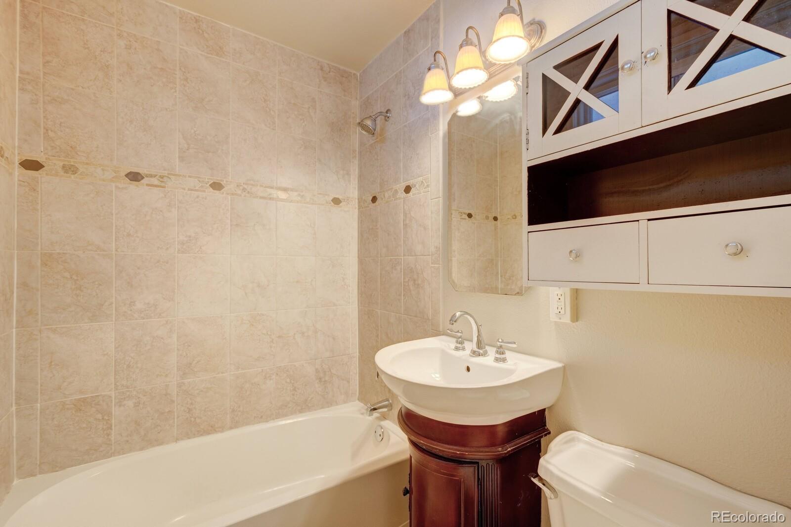 7928 Raleigh Place Westminster, CO 80030 - Photo 11 of 24 a bathroom with a sink a toilet and bathtub