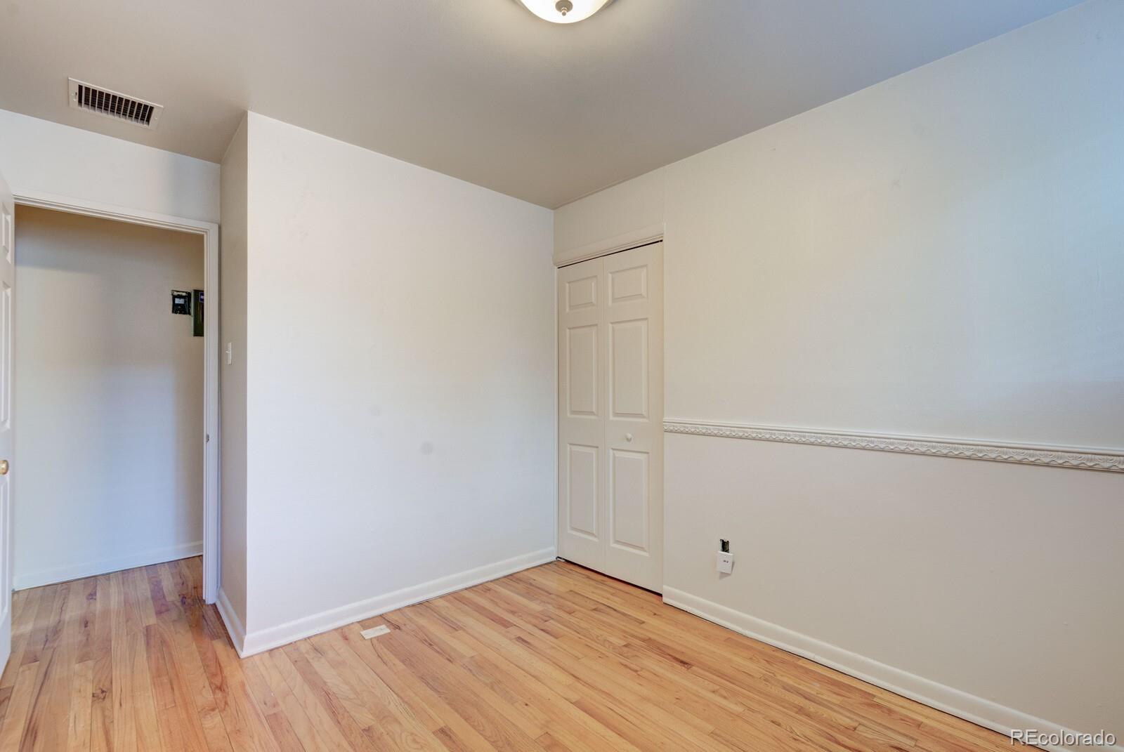 7928 Raleigh Place Westminster, CO 80030 - Photo 15 of 24 a view of an empty room with wooden floor