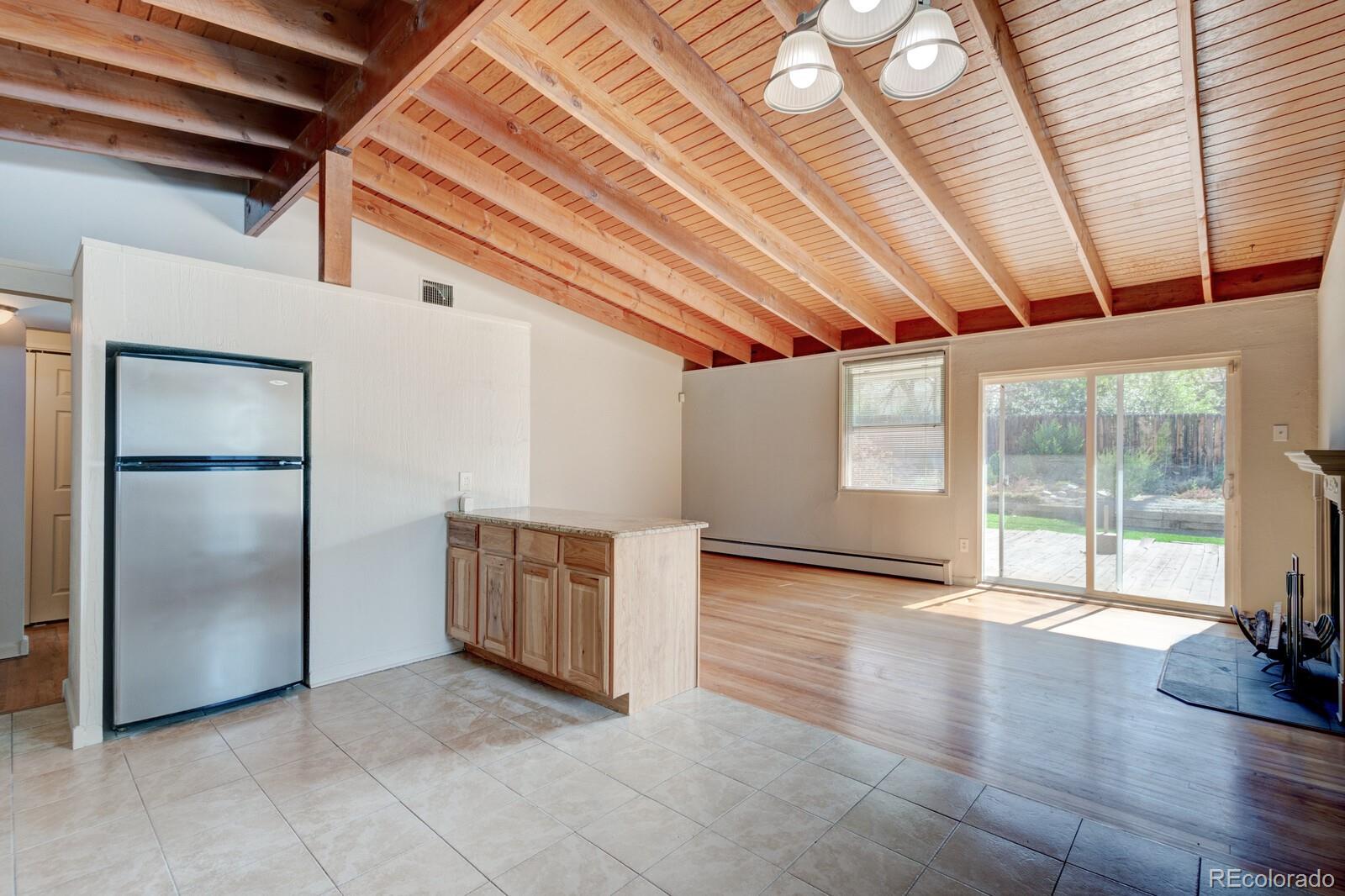 7928 Raleigh Place Westminster, CO 80030 - Photo 5 of 24 an empty room with wooden floor and windows