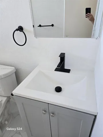 a kitchen with a cabinets and chandelier