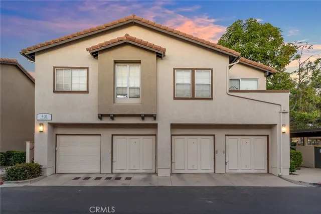 a front view of a house with garage
