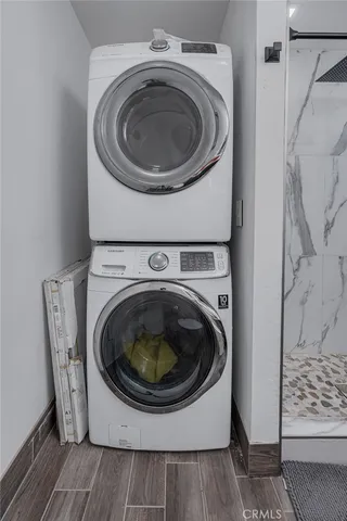 a bedroom with a bed and a flat tv screen on the dresser