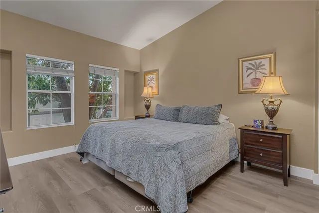 a bedroom with a bed and a television