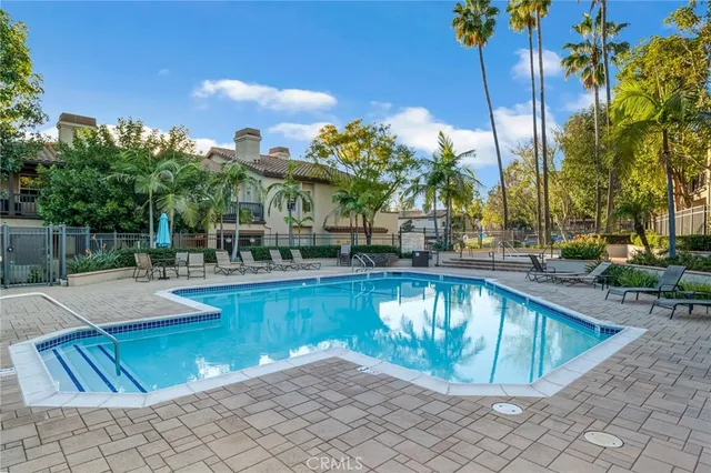 a view of a house with pool and chairs