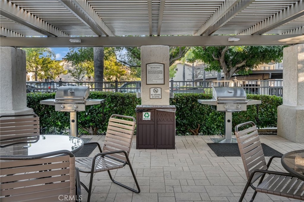 28 Vía Contento Rancho Santa Margarita, CA 92688 - Photo 48 of 61 a front view of a house with a garden and outdoor seating