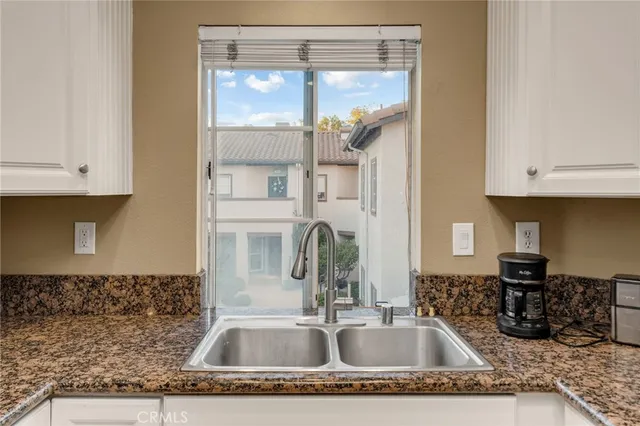 a kitchen with a refrigerator and a sink