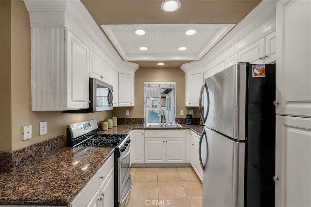 28 Vía Contento Rancho Santa Margarita, CA 92688 - Photo 9 of 61 a kitchen with stainless steel appliances granite countertop a refrigerator sink and stove