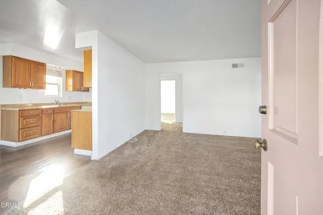 a view of a kitchen with a sink and a refrigerator