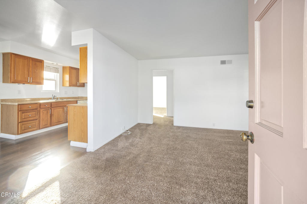 a view of a kitchen with a sink and a refrigerator
