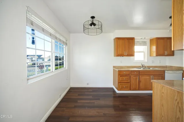 a kitchen with a stove a sink and a refrigerator