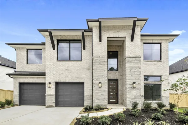 a front view of a house with garage