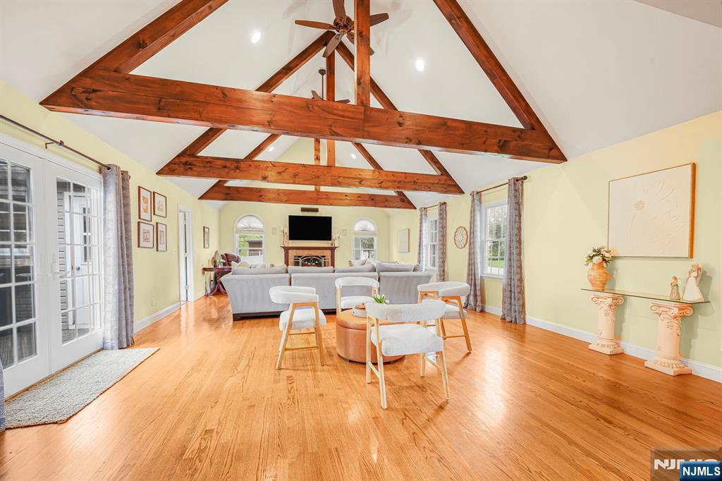 30 Oakley Way Wayne, NJ 07470 - Photo 13 of 43 a living room with furniture a flat screen tv and a wooden floor