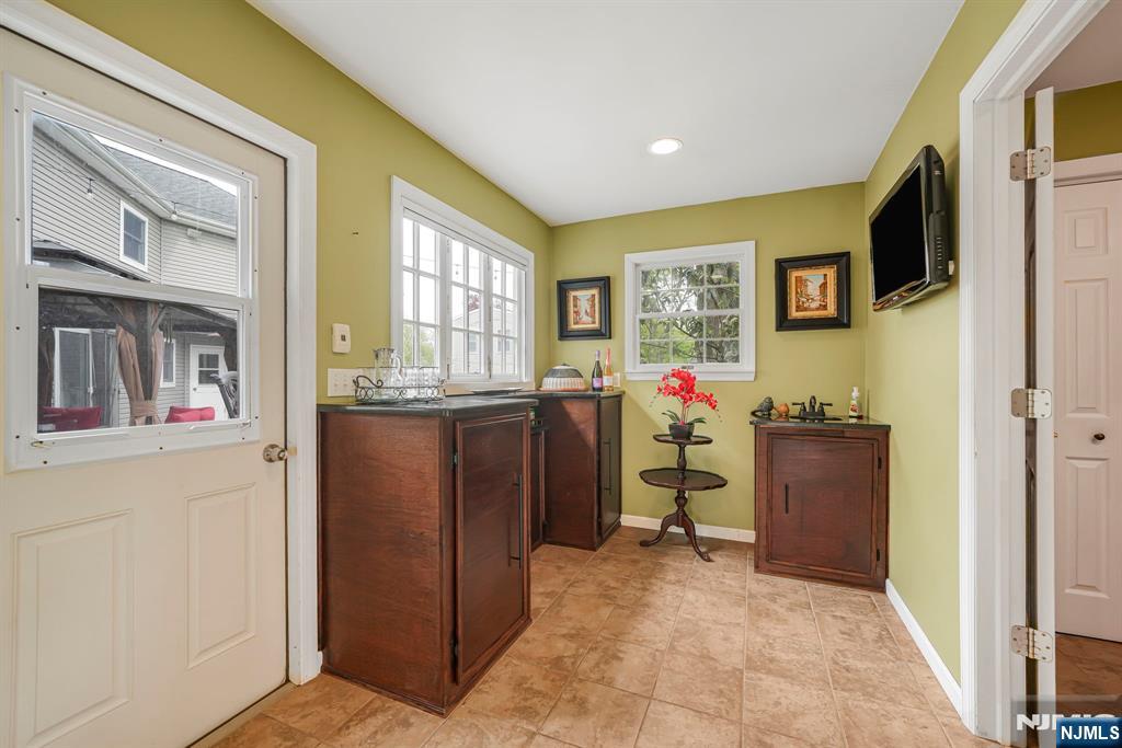 30 Oakley Way Wayne, NJ 07470 - Photo 16 of 43 a living room with furniture a flat screen tv and a refrigerator