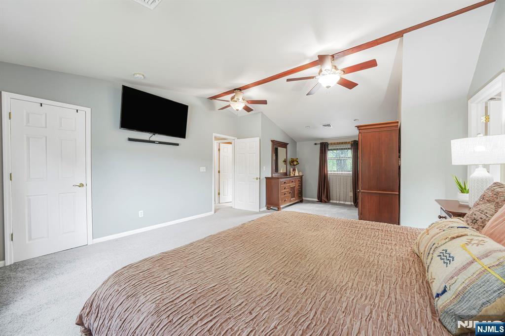 30 Oakley Way Wayne, NJ 07470 - Photo 21 of 43 a bedroom with a bed and a flat screen tv