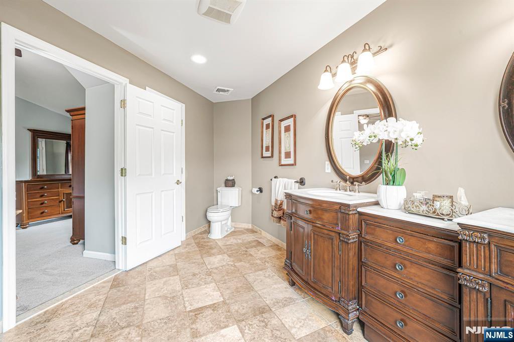30 Oakley Way Wayne, NJ 07470 - Photo 22 of 43 a spacious bathroom with a double vanity sink a mirror and a shower