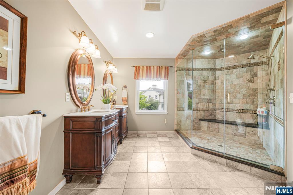 30 Oakley Way Wayne, NJ 07470 - Photo 23 of 43 a bathroom with a sink a mirror and a shower