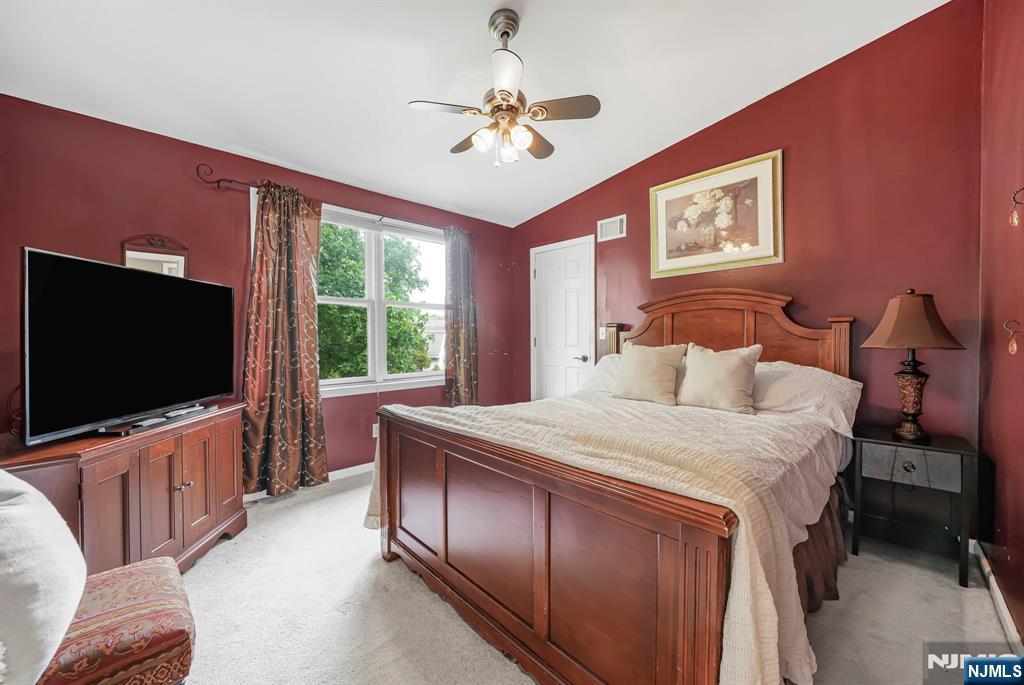 30 Oakley Way Wayne, NJ 07470 - Photo 24 of 43 a bedroom with a bed and a flat screen tv
