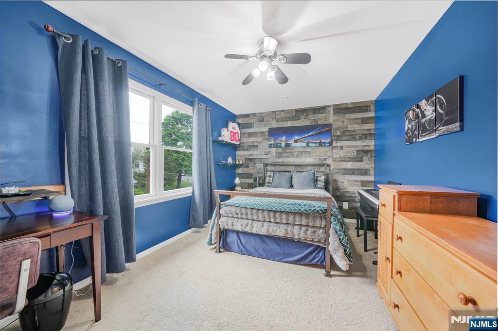 30 Oakley Way Wayne, NJ 07470 - Photo 26 of 43 a bedroom with a bed and a chandelier