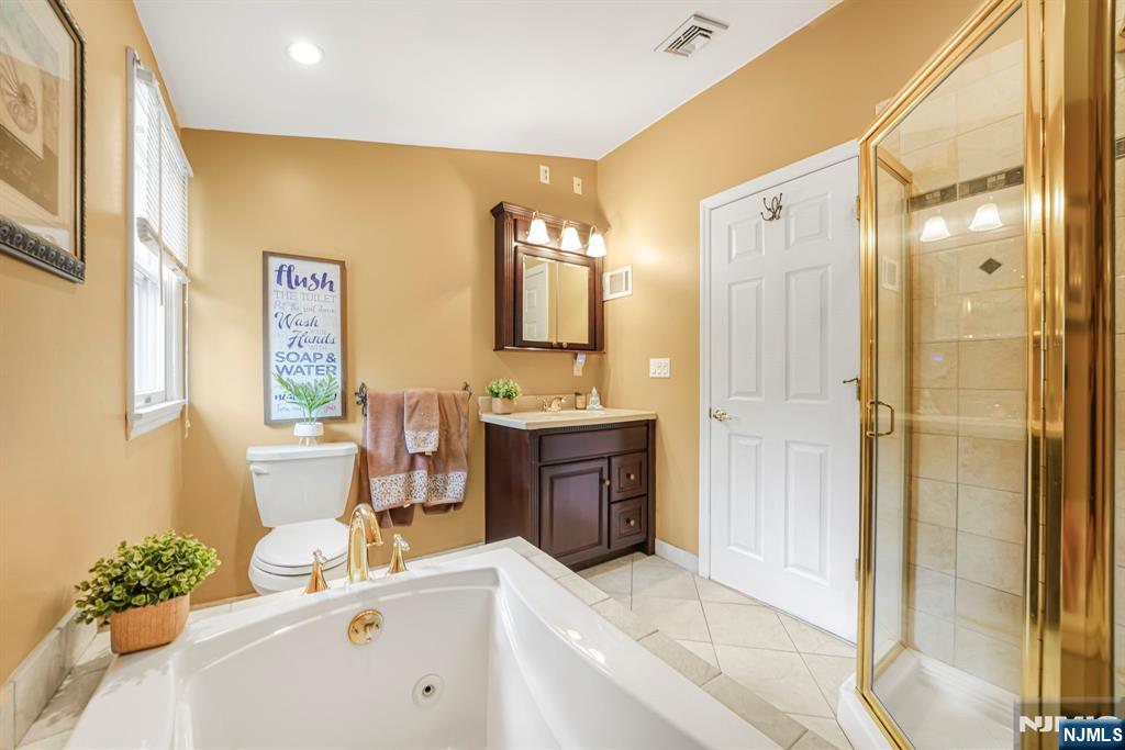 30 Oakley Way Wayne, NJ 07470 - Photo 28 of 43 a bath room with a sink double vanity granite tub shower and mirror