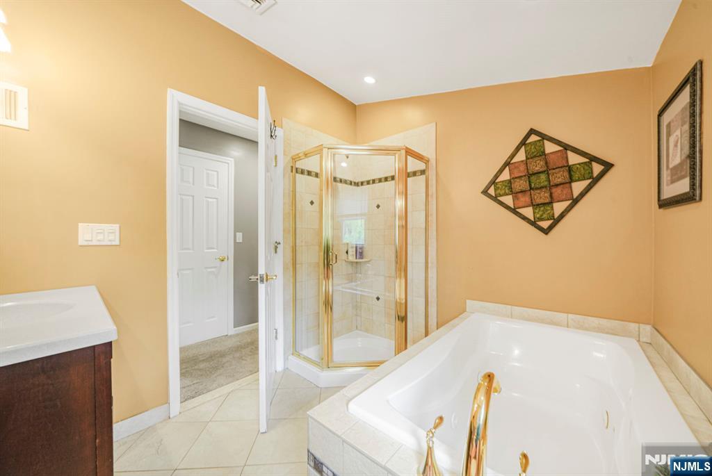 30 Oakley Way Wayne, NJ 07470 - Photo 29 of 43 a bathroom with a tub shower and sink