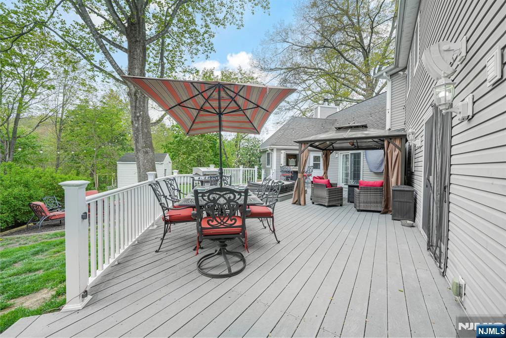 30 Oakley Way Wayne, NJ 07470 - Photo 36 of 43 a view of a deck with table and chairs and wooden floor