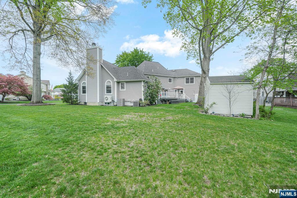 30 Oakley Way Wayne, NJ 07470 - Photo 38 of 43 a white house that has a tree in front of it