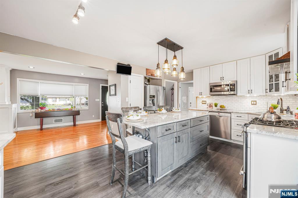 30 Oakley Way Wayne, NJ 07470 - Photo 7 of 43 a kitchen with stainless steel appliances granite countertop a stove oven and a refrigerator