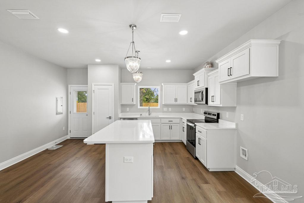 5307 Edeker Circle Jay, FL 32565 - Photo 11 of 28 a kitchen with cabinets wooden floor and stainless steel appliances