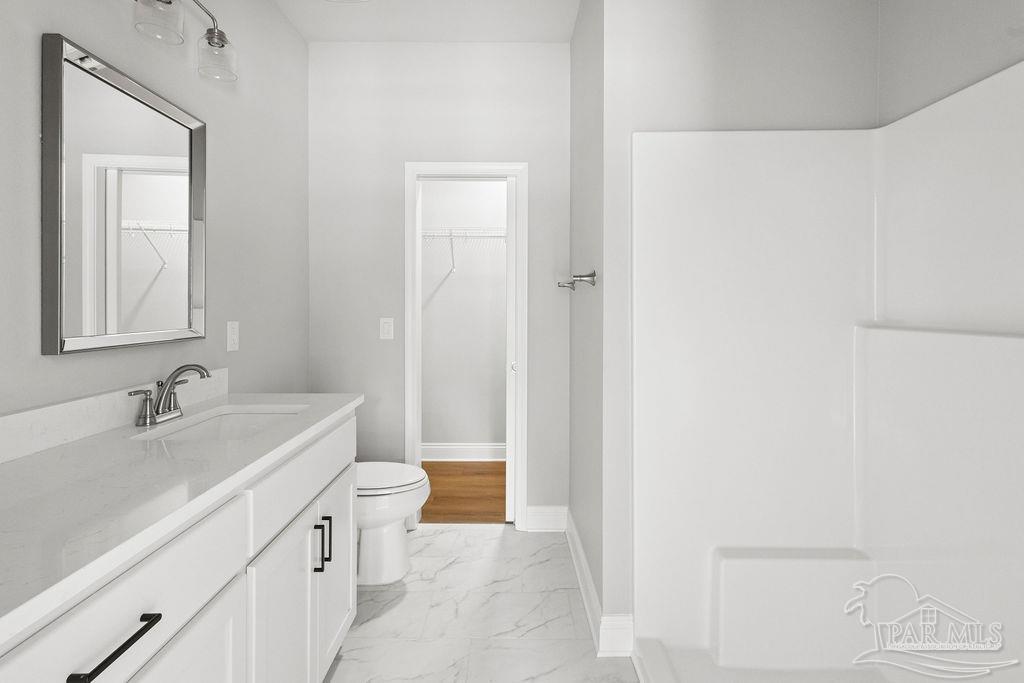 5307 Edeker Circle Jay, FL 32565 - Photo 17 of 28 a bathroom with a sink a toilet and vanity