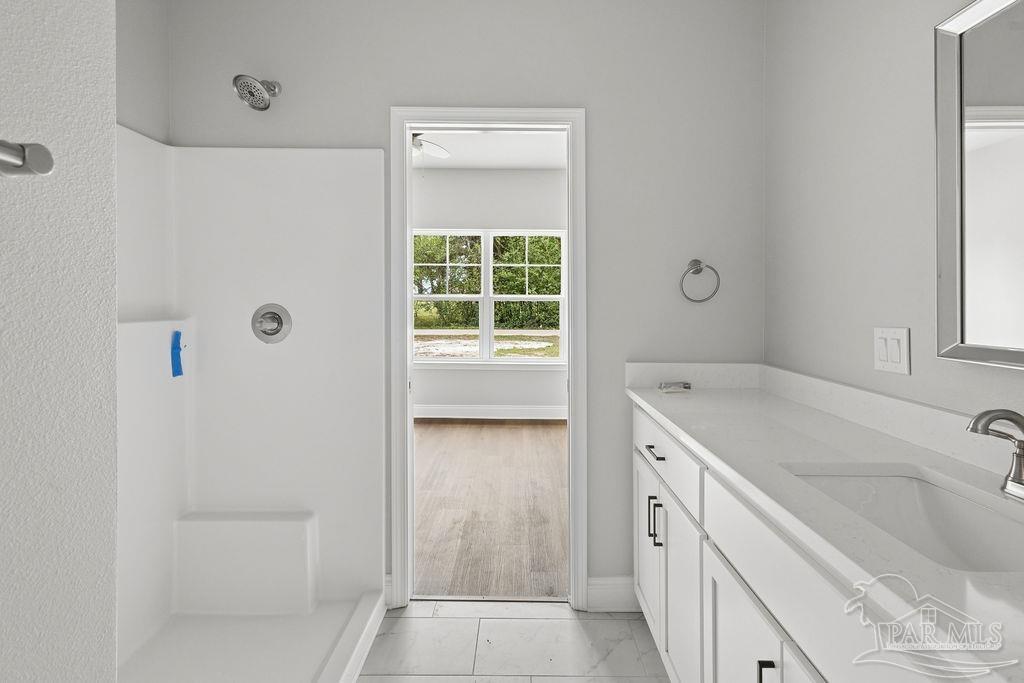 5307 Edeker Circle Jay, FL 32565 - Photo 18 of 28 a bathroom with a granite countertop sink a toilet and shower