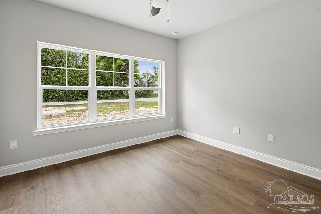 5307 Edeker Circle Jay, FL 32565 - Photo 19 of 28 an empty room with wooden floor and windows