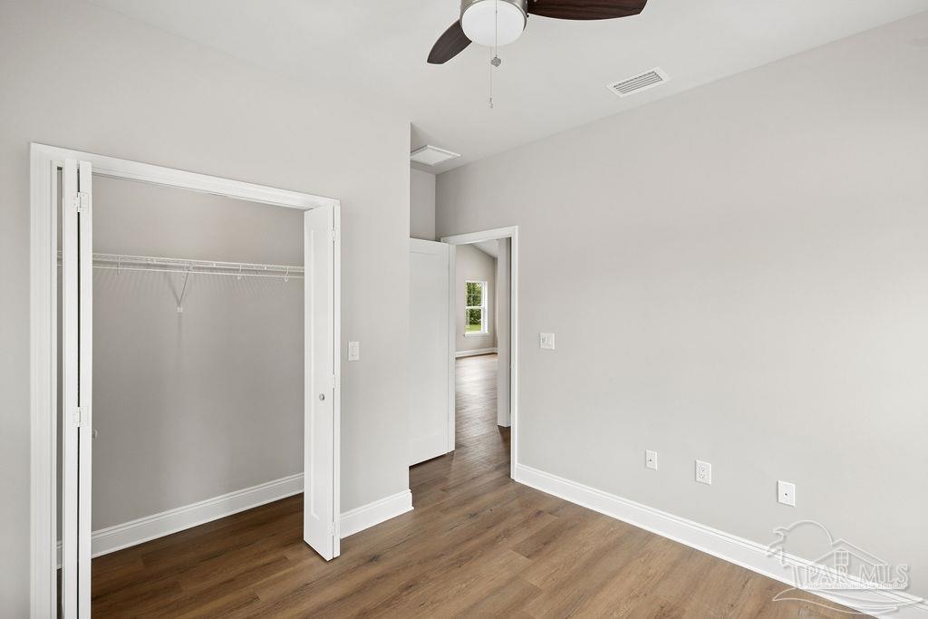 5307 Edeker Circle Jay, FL 32565 - Photo 20 of 28 an empty room with wooden floor