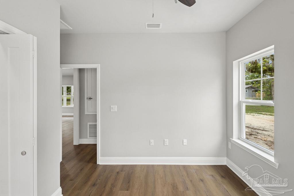 5307 Edeker Circle Jay, FL 32565 - Photo 21 of 28 an empty room with wooden floor and windows