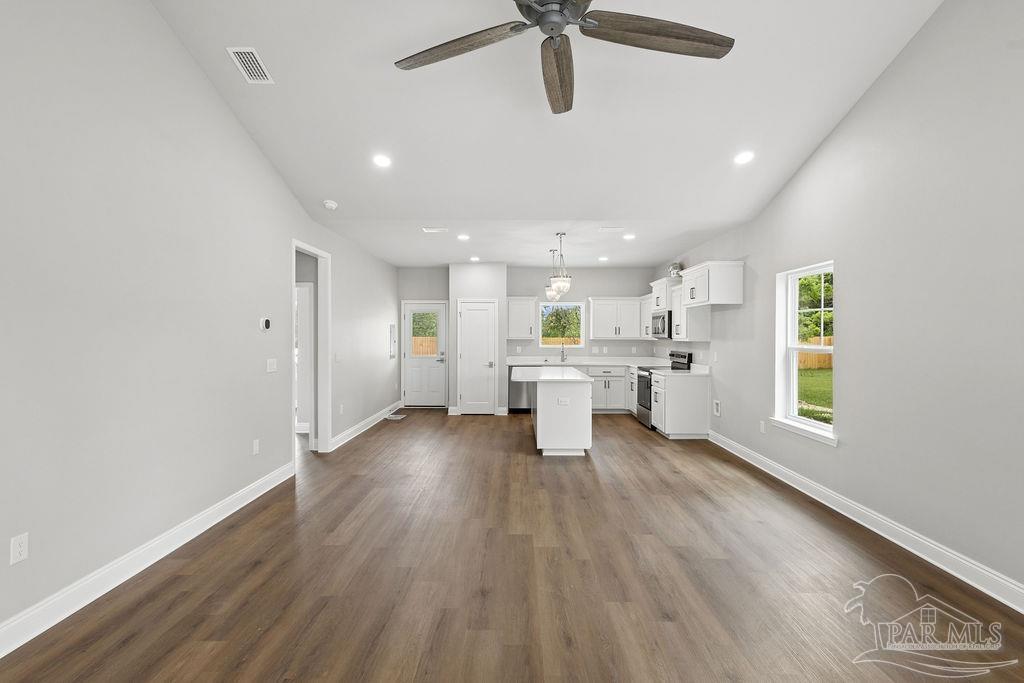 5307 Edeker Circle Jay, FL 32565 - Photo 4 of 28 a view of a kitchen with a sink and dishwasher a refrigerator with wooden floor
