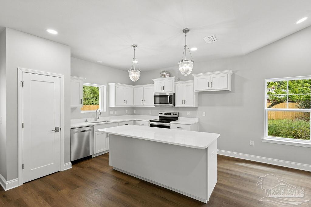 5307 Edeker Circle Jay, FL 32565 - Photo 10 of 28 a kitchen with stainless steel appliances a white stove top oven sink and cabinets