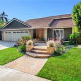 a front view of a house with a yard garden and outdoor seating