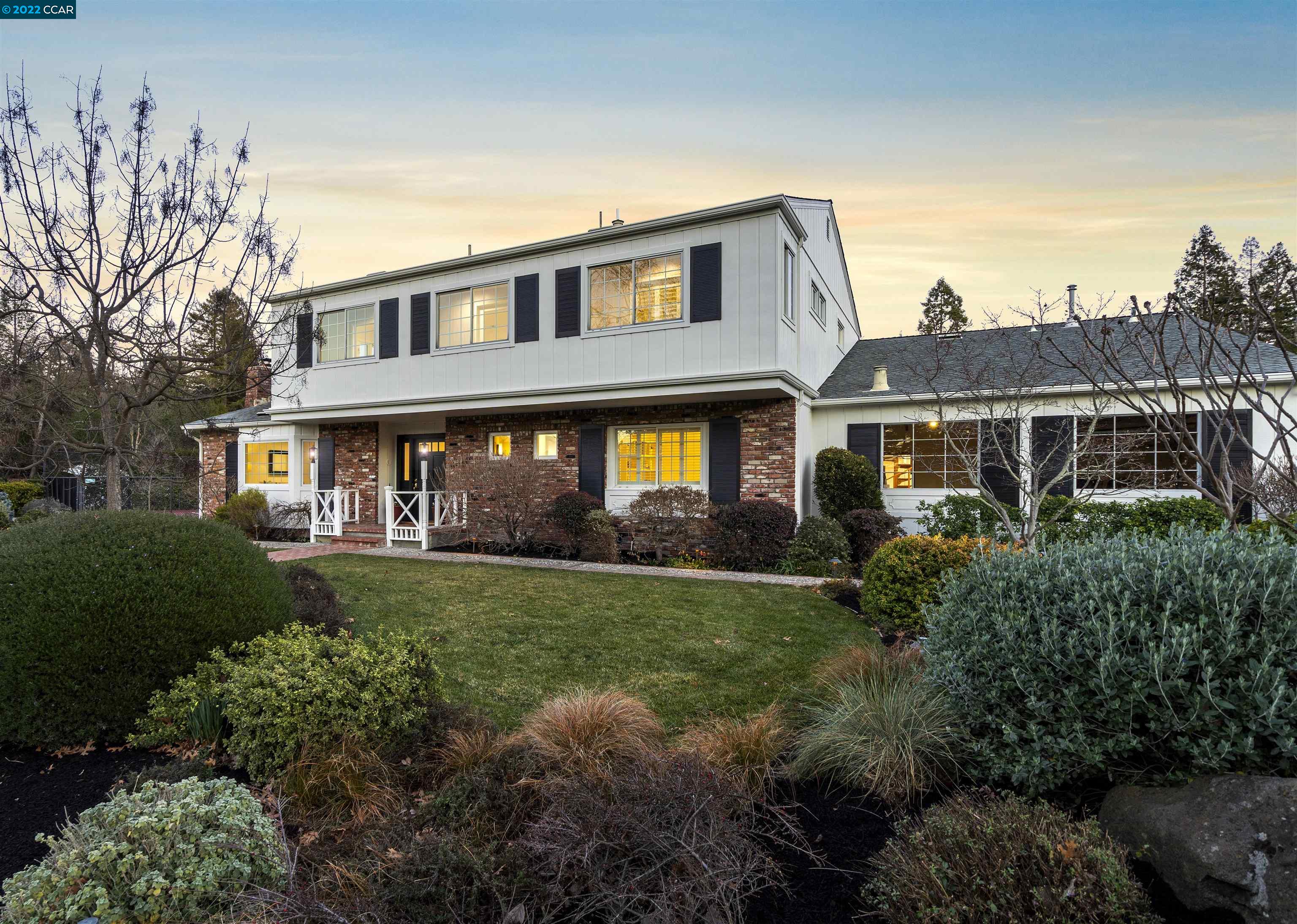 a front view of house with yard and green space