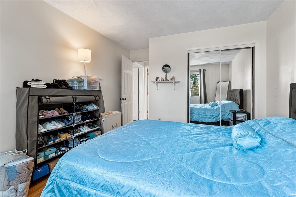 6 Erick Road, Unit 75 Mansfield, MA 02048 - Photo 13 of 20 a bedroom with a bed and a cabinets